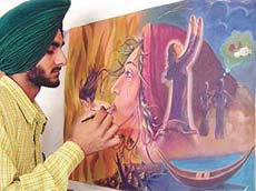 Shingara Singh, a painter in the making, gives final touches to his paintings.