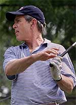US President George W. Bush tees off one the first tee of the Andrew Air Force Base Golf Course