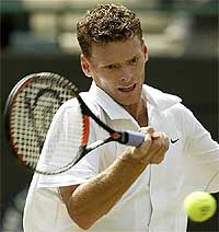 The Netherlands' Sjeng Schalken returns the ball to Australia's Lleyton Hewitt