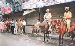 Mounted police on guard in Gur Mandi as shopkeepers kept their shops closed in protest against police raid on the shops yesterday evening.