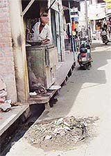 Garbage cleaned out of a drain waiting to be disposed of for the past two days at the main market in Machhiwara on Saturday.