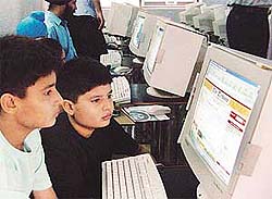 Kids view the site, tribuneindia.com, after the inauguration of a cyber cafe and online education centre at Tagore Nagar in Ludhiana on Saturday.