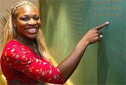 Serena Williams points to her name on the Women�s Singles Champions roll of honour in the Clubhouse at the All England Lawn Tennis Club at Wimbledon 