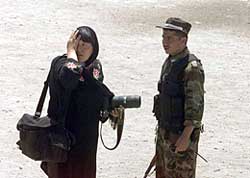 A Japanese photographer holds her face