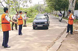 NSS volunteers in action at the admission venue for government schools in GMSSS-23. Students have been entrusted with the task of managing traffic during the ongoing admission season. 