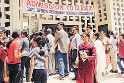 Students and parents await their turn for counselling at the centralised admissions for Class XI in government schools, at GMSSS 23, on Monday.