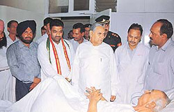 The Haryana Governor, Babu Parmanand, enquires about the health of Mr Kultar Singh, younger brother of Shaheed Bhagat Singh, at the PGI on Monday.