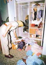 A policeman examines the room where 20-year-old Ritika Malik was found murdered