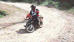 Surhid Sharma takes a turn on way before winning the 8th BSNL Highland Scooter and Motorcycle Rally.