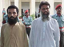 Pakistani soldiers escort Mohammad Imran  and Mohammad Hanif , belonging to the banned Islamic militant group Harkat-ul-Mujahideen