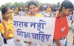 Schoolchildren protest against the Delhi Government�s new liquor policy at India Gate
