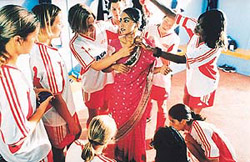 Jess (played by Parminder Nagra) in the midst of her teammates in the movie �Bend it like Beckham�.