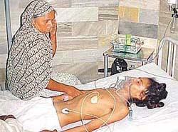 Jagroop Singh, with his mother at the bedside, the day he was admitted to the hospital