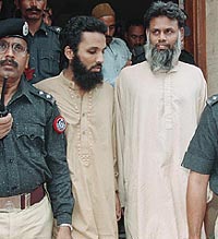 Islamic militants Mohammad Imran and Mohammad Hanif leave a court in Karachi 