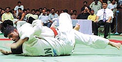 Sandeep Singh in red belt (Haryana) pins down Karambeer Singh (BSF) in the National Federation Cup Judo Championship 2002