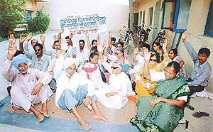 Members of the Handicapped Institution Employees Federation sit on a dharna at the VRTC 