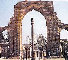 The Iron Pillar at Delhi seen through an arch