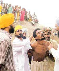 Villagers rough up a man alleged to be a robber