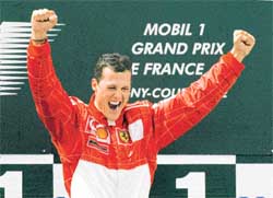 Formula One driver Michael Schumacher of Germany celebrates on the podium
