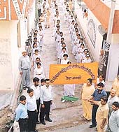 Students of various schools associated with the local Saravhitkari Vidya Mandir School at a procession to mark the golden jubilee of Vidya Bharti
