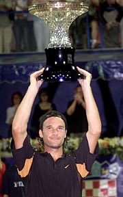 Carlos Moya of Spain raises the trophy