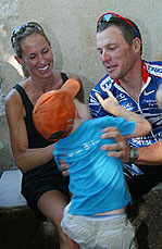 US Postal team rider Lance Armstrong of the USA and his wife Kristin play with their son
