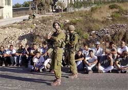 Two Israeli soldiers stand guard