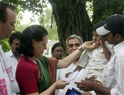 Congress President Sonia Gandhi consoles a riot victim