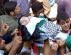 Palestinians carry the body of a two-month old baby