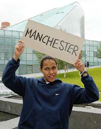 Australia's Cathy Freeman holds up a banner