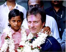 Former Australian cricket captain Steve Waugh with a handicapped child
