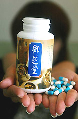 An office worker displays Onshido brand Chinese diet pills