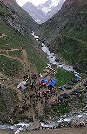 Devotees pass by mountains