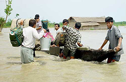 Flood victims make their way through floodwaters