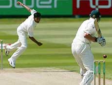 England batsman Andrew Flintoff hits a ball from India's bowler Ajit Agarkar
