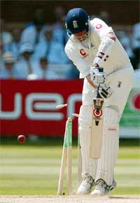 England batsman Ashley Giles is bowled out by Ashish Nehra