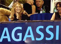 Tennis great Steffi Graf watches her husband Andre Agassi play