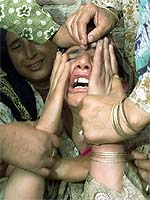 An unidentified relative wails over the death of Mohammed Qasim and his son Ghulam Mohammed, who died during a grenade attack at the town of Budgam, 15 km west of Srinagar, on Saturday.