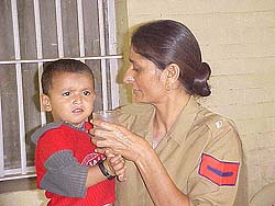 Two-year-old Ishu, who was rescued by the police, is seen with a policewoman