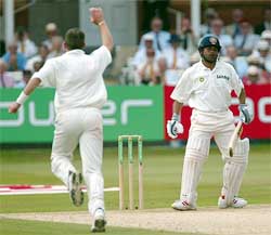 England bowler Craig White celebrates as Indian batsman Sachin Tendulkar looks dejected 
