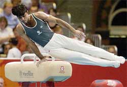 India�s Vikas Pandey performs on the parallel bars