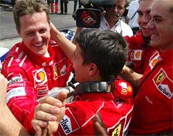 Michael Schumacher celebrates claming pole position