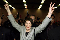 New Zealand Prime Minister Helen Clark raises her arms in triumph