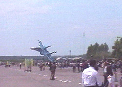 A TV frame shows spectators looking on