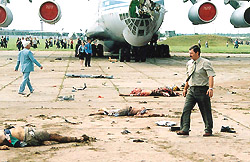 A man walk past victims' bodies
