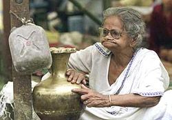 A woman waits for food at a relief camp