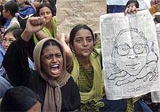 Female students of Bangladesh's premier Dhaka University shout slogans during a protest demanding the resignation of Vice-Chancellor Anwarullah Chowdhury on Sunday.