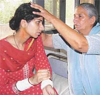Mother of 21-yr-old Jasbir Kaur shows the injuries inflicted on her daughter by her husband
