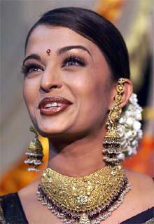 Actress Aishwarya Rai smiles as she poses for photographers