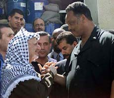 Palestinian President Yasser Arafat greets US civil rights leader Rev Jesse Jackson at his compound in the West Bank city of Ramallah on Monday.